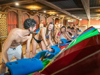 Excited guests prepare to race down the Vikingløp speed slide at Rulantica on their mats.