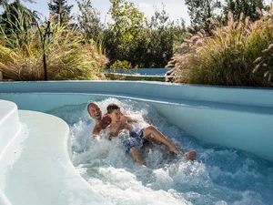 Father and son let themselves be carried away by the wild current of the outdoor attraction Vildstrøm.