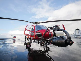 Red helicopter with large camera films scenes for the Flying Theater.