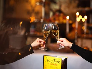 Two people toast with champagne at the New York Sunday Brunch at hotel 'Bell Rock'.