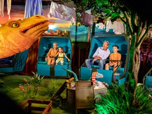Family sitting in the Madame Freudenreich Curiosités attraction at Europa-Park.