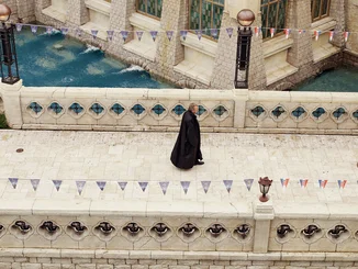 Michael Mack walks through the Croatian themed area wearing a long, dark coat.