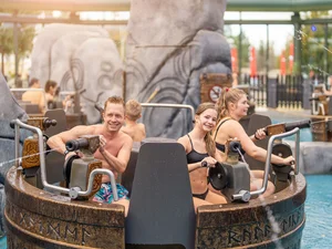 Family engages in a water fight on the interactive water carousel Tønnevirvel at Rulantica water world.