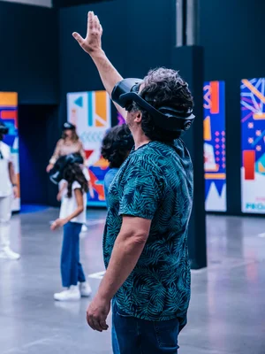 Man wearing a VR headset extends his hand.