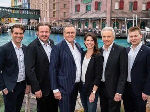 Roland Mack stands in front of the lake at the themed 4* superior hotel ‘Krønasår’ with his children Michael, Thomas and Ann-Kathrin Mack, his brother Jürgen Mack and his son Frederik Mack.