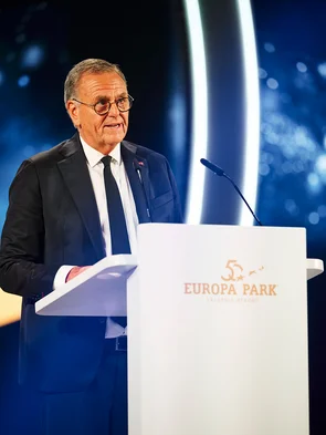 Roland Mack gives a speech on stage at the gala celebrating Europa-Park's 50th anniversary.