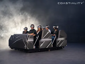Passengers sit in the Flowryde, equipped with VR headsets.