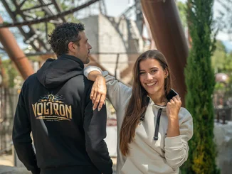 Couple wearing the stylish Voltron Nevera hoodie during their visit to Europa-Park.