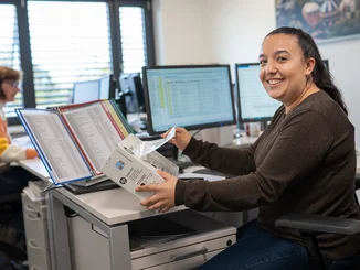 An employee of the central purchasing department at Europa-Park sits in her office and works.