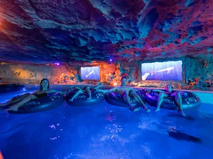 Family sits in swimming tubes and drifts through the Snorri's Saga attraction in Rulantica.