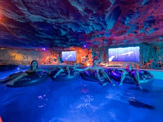 Family sits in swimming tubes and drifts through the Snorri's Saga attraction in Rulantica.