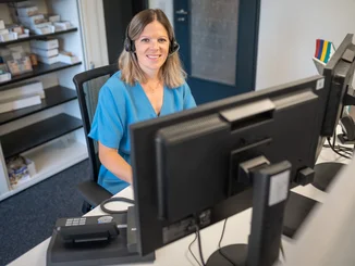 Europa-Park guest services employee working on a computer.