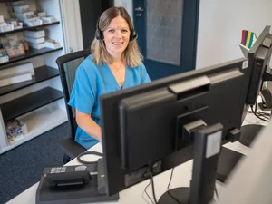 Europa-Park guest services employee working on a computer.