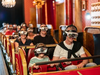 Passengers sit on Eurosat Coastiality – The Phantom of the Opera VR attraction at Europa-Park. Everyone is equipped with VR headsets.
