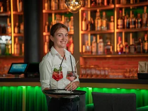 An employee at the Europa-Park Resort carries two delicious cocktails on a tray.