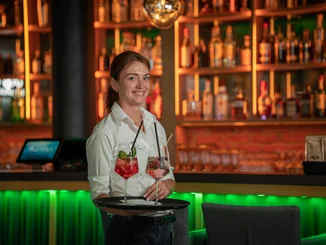 An employee at the Europa-Park Resort carries two delicious cocktails on a tray.