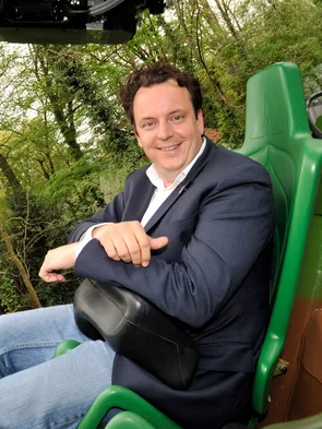 Michael Mack sits on the attraction ARTHUR at Europa-Park.