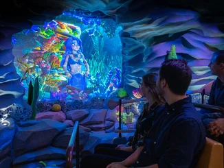 Visitors sit in a boat on the Snorri Touren attraction.