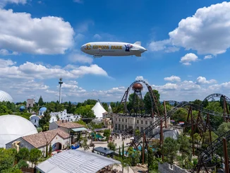 The Europa-Park Zeppelin, commemorating the park's 50th anniversary, hovers above the Croatian themed area.