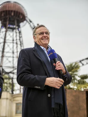 Roland Mack gives a speech at the opening of the Croatian themed area. In the background, Voltron Nevera powered by Rimac.
