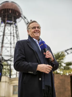 Roland Mack gives a speech at the opening of the Croatian themed area. In the background, Voltron Nevera powered by Rimac.