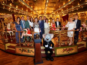 The Mack family of entrepreneurs, together with the Euromaus, on an old carousel.