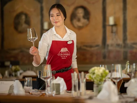 Gastronomy employee at the Europa-Park Resort waiting on a table.