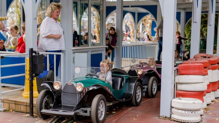 Children sit in small vintage cars at the Lada Autodrom in the Russian themed area of Europa-Park.