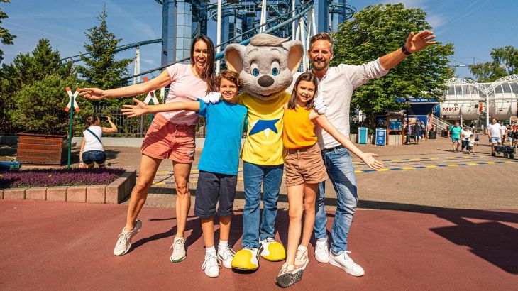 Une famille se tient avec Ed Euromaus devant l’attraction Euro-Mir dans le quartier russe d’Europa-Park.