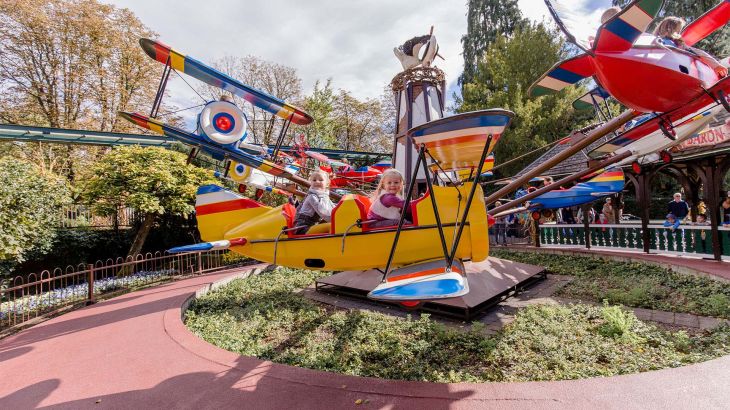 Two children on the Red Baron attraction in the Dutch themed area at Europa-Park.