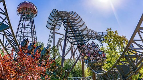 The attraction Voltron Nevera powered by Rimac, at Europa-Park in late summer, set against a backdrop of autumnal trees.